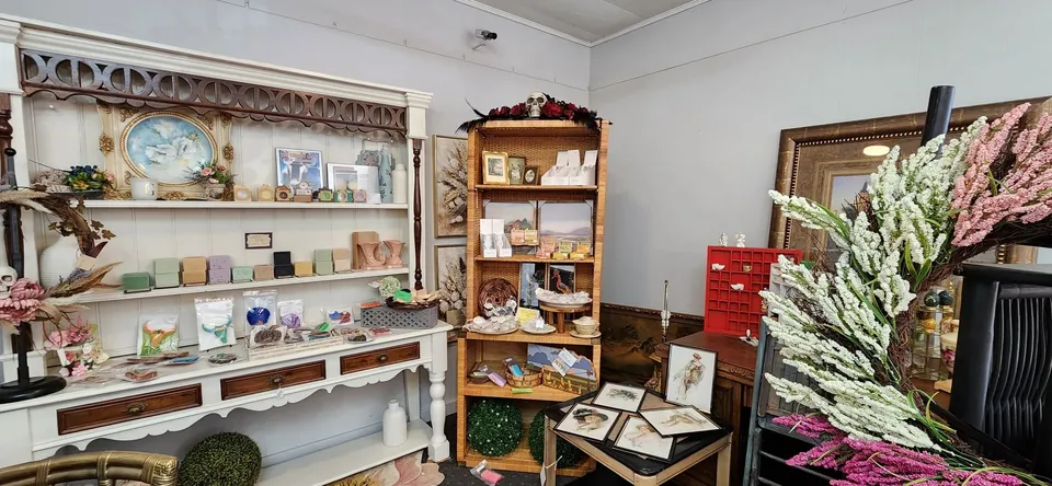 Shelves of stock, including candles and a wreath.