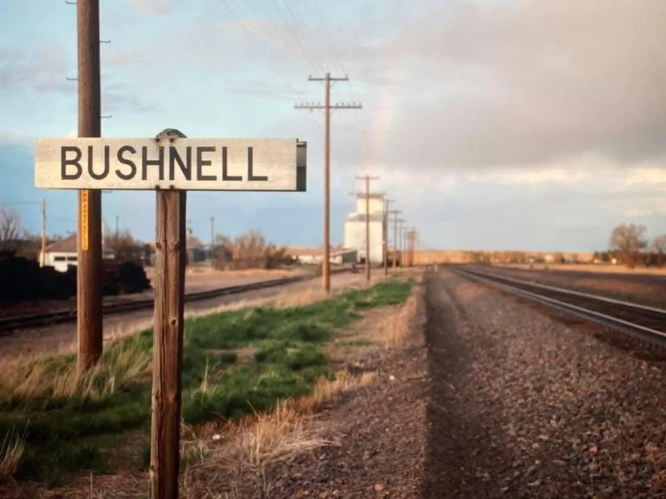 Bushnell sign beside railroad tracks