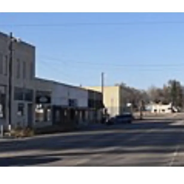 Quiet small-town main street under a clear blue sky